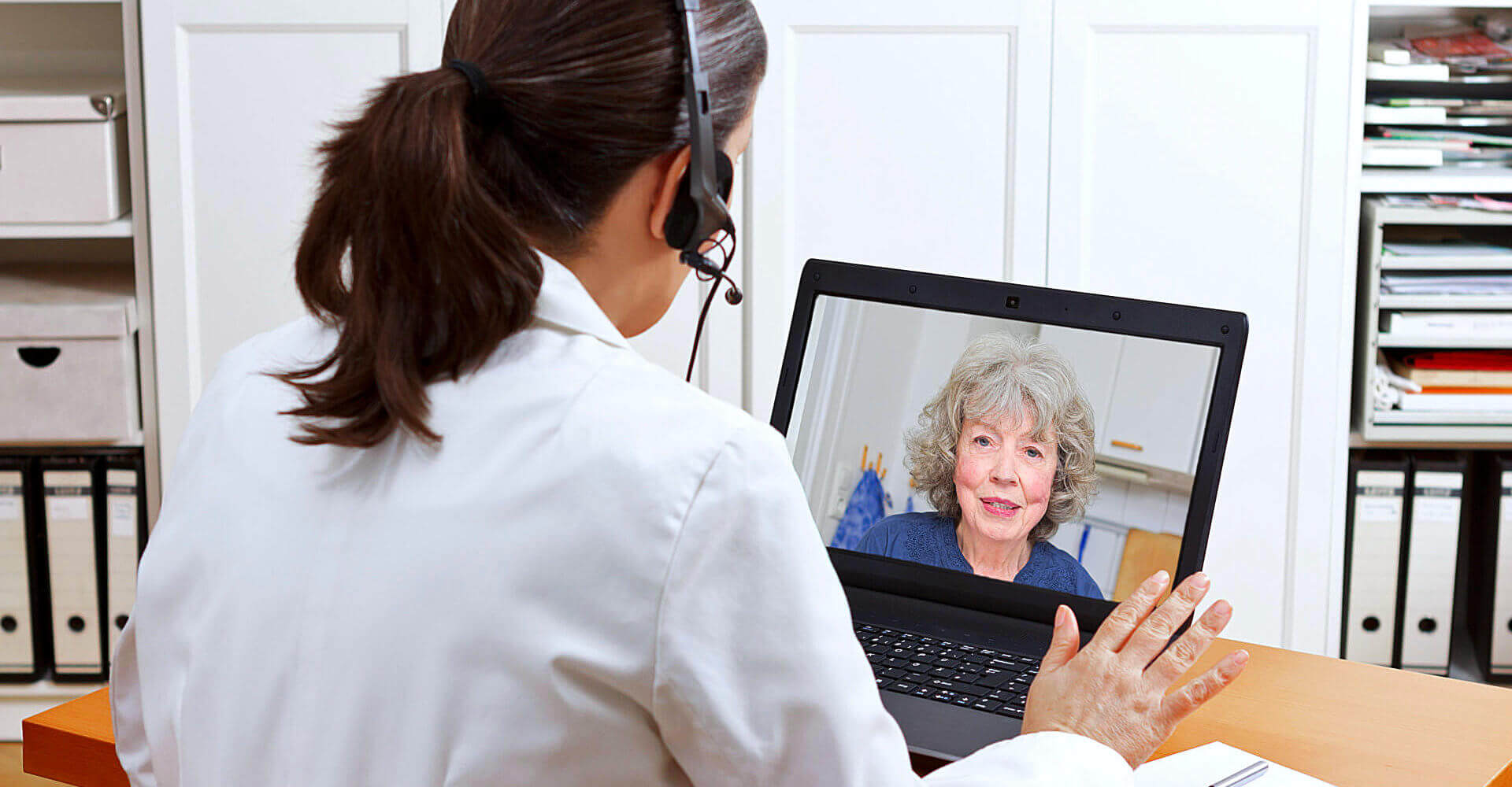 adult woman and senior woman talking through laptop