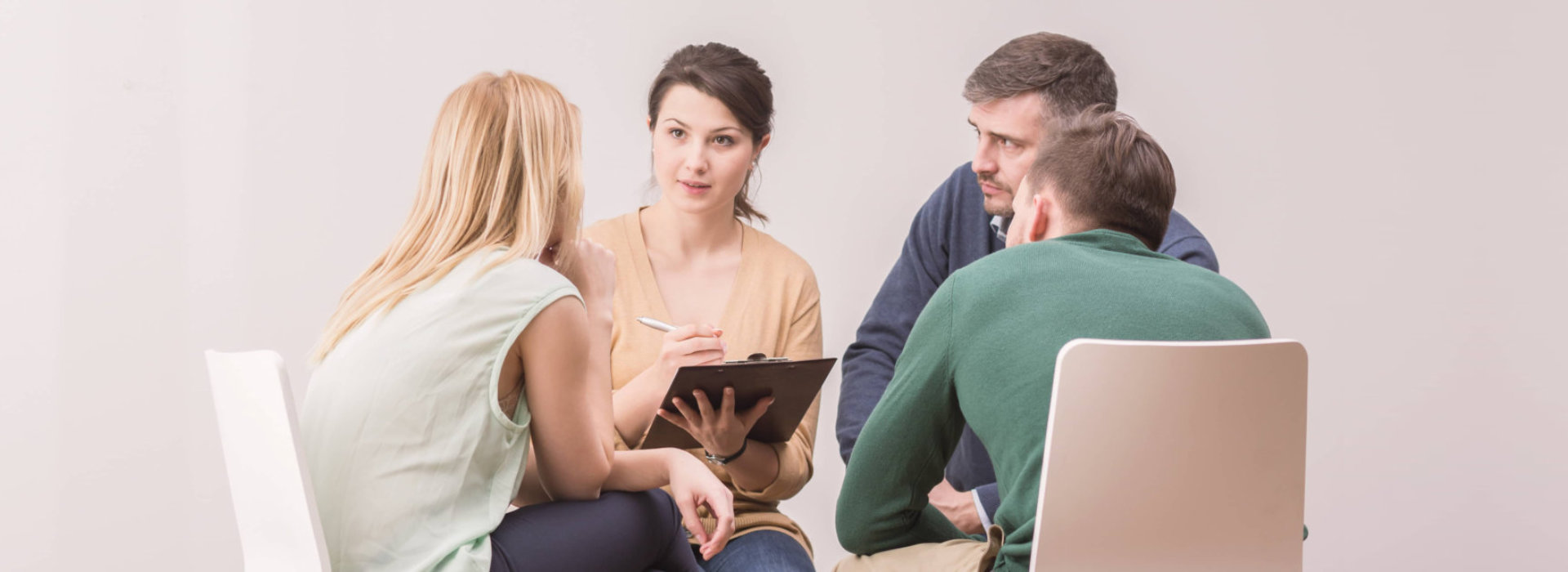 group of people talking to a counselor